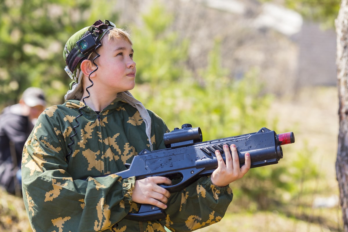 a boy with a laser tag gun